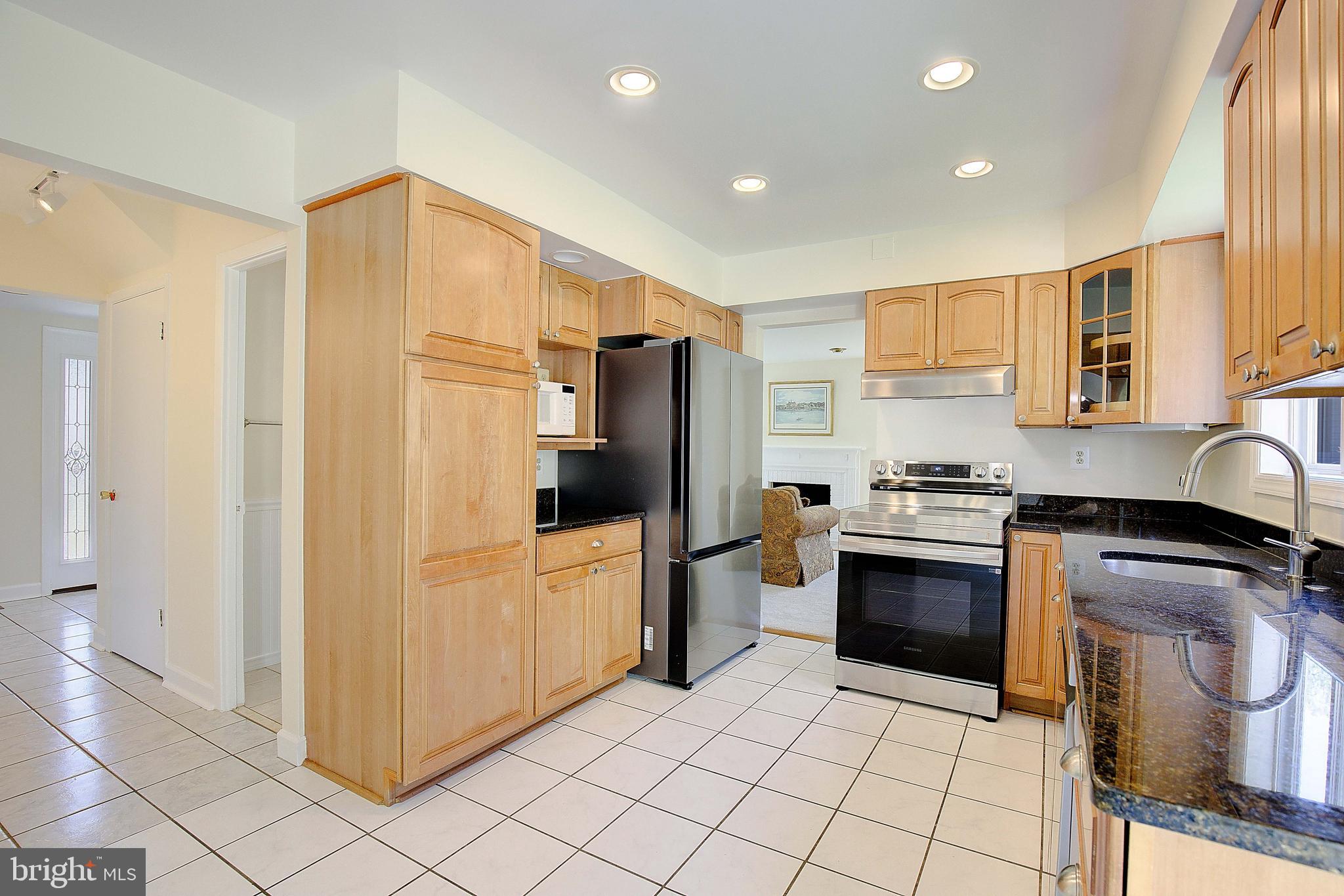12702 Cedarbrook Lane Laurel, MD 20708 - Photo 12 of 43 a kitchen with stainless steel appliances granite countertop a refrigerator and a stove top oven