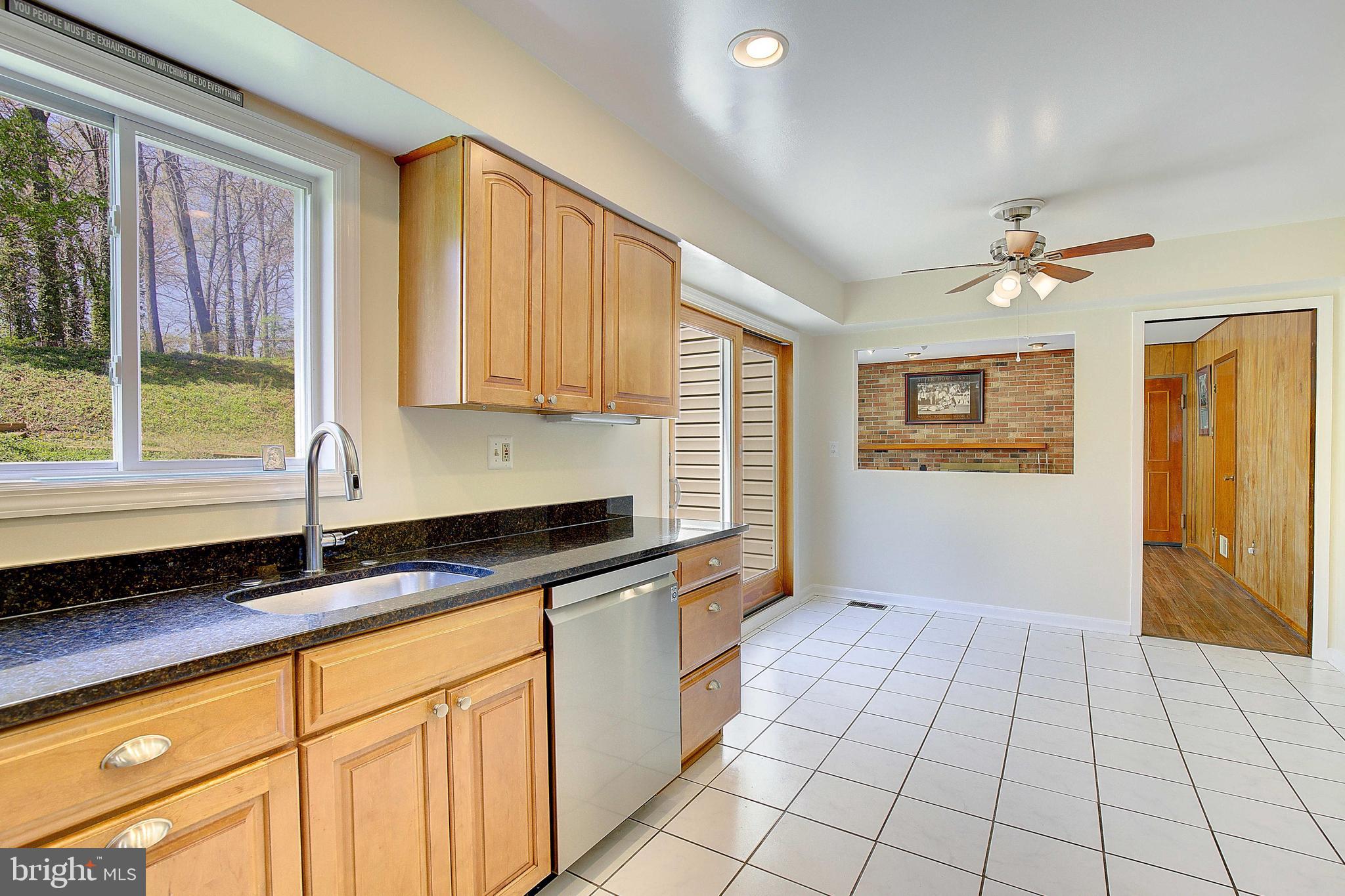12702 Cedarbrook Lane Laurel, MD 20708 - Photo 14 of 43 a kitchen with granite countertop a sink a stove cabinets and black stainless steel appliances