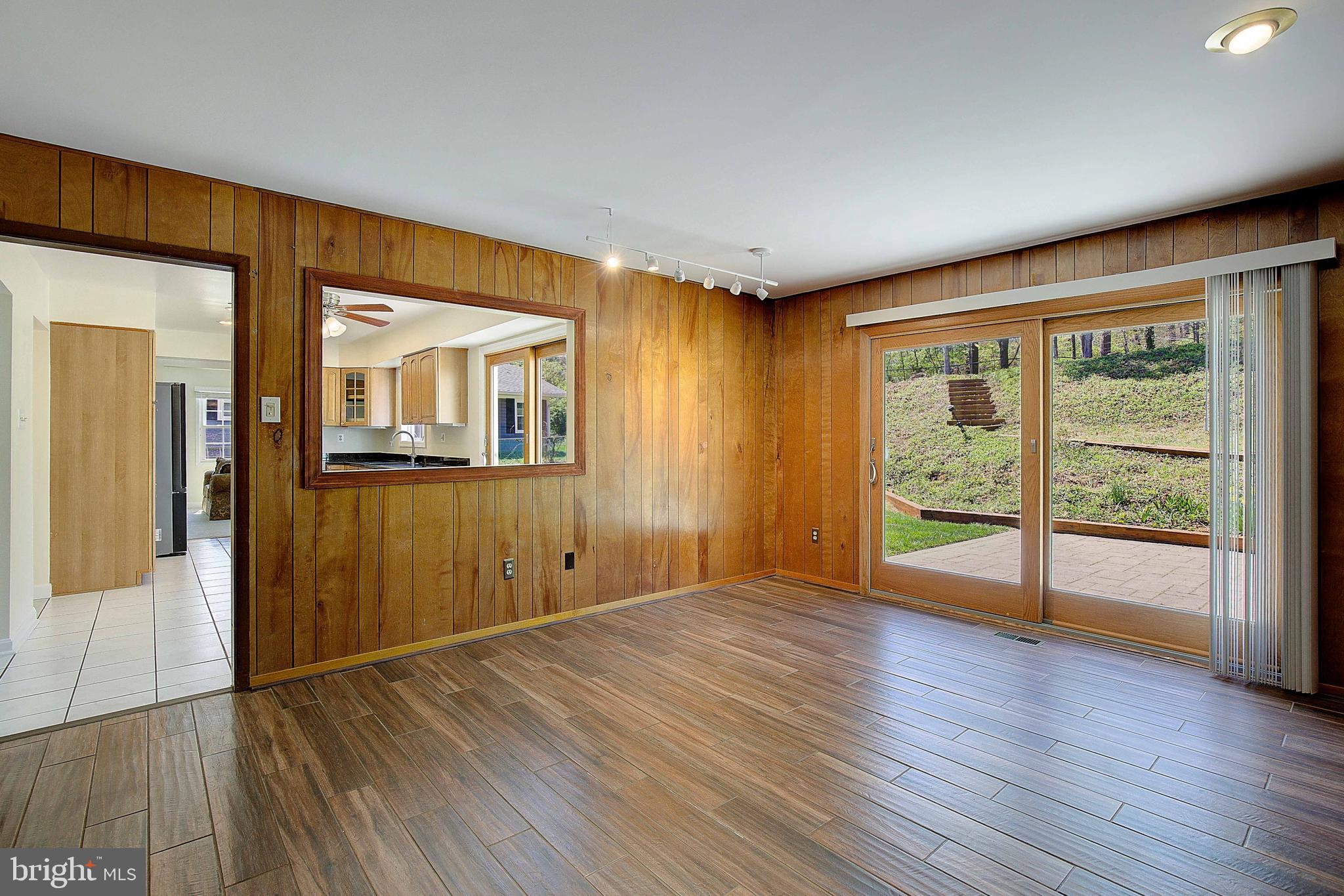12702 Cedarbrook Lane Laurel, MD 20708 - Photo 18 of 43 a view of an empty room with wooden floor and a window