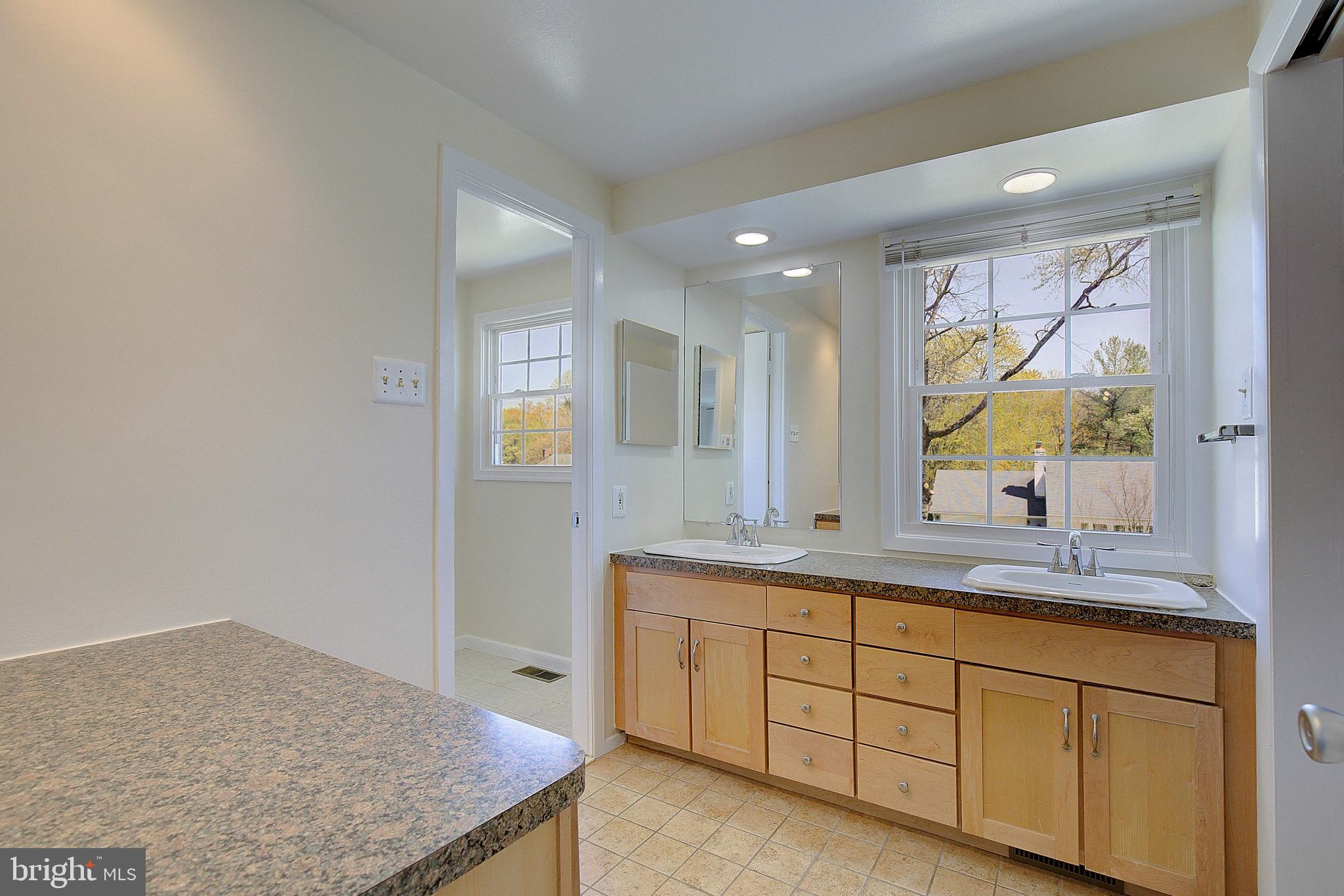 12702 Cedarbrook Lane Laurel, MD 20708 - Photo 33 of 43 a bathroom with a granite countertop sink mirror and double