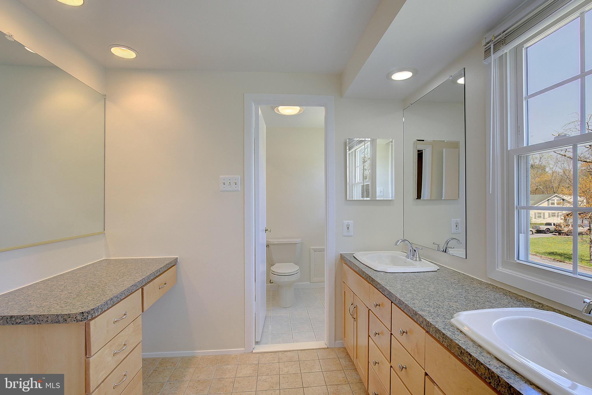 12702 Cedarbrook Lane Laurel, MD 20708 - Photo 34 of 43 a bathroom with a granite countertop sink and a mirror