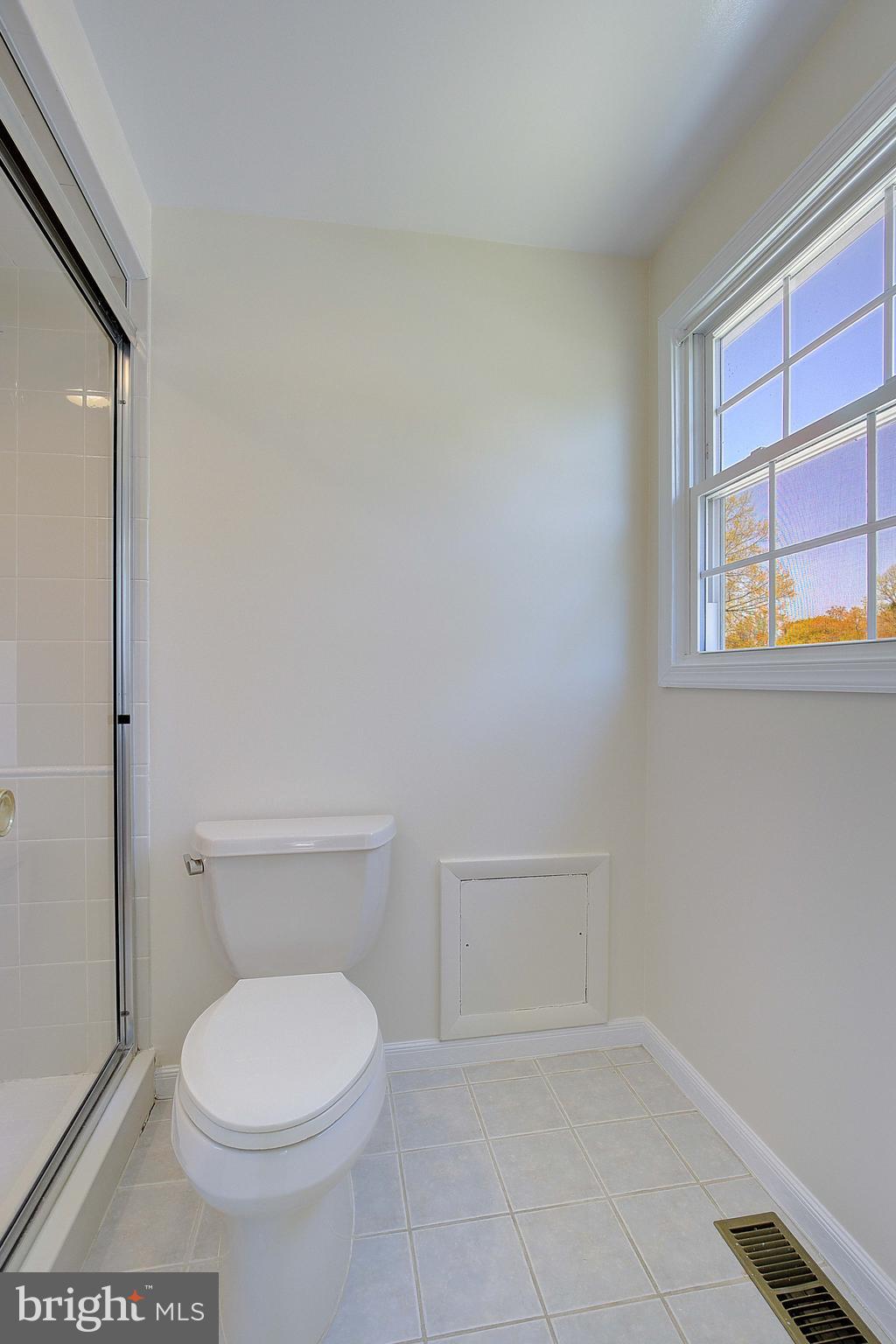 12702 Cedarbrook Lane Laurel, MD 20708 - Photo 36 of 43 a white toilet sitting next to a window