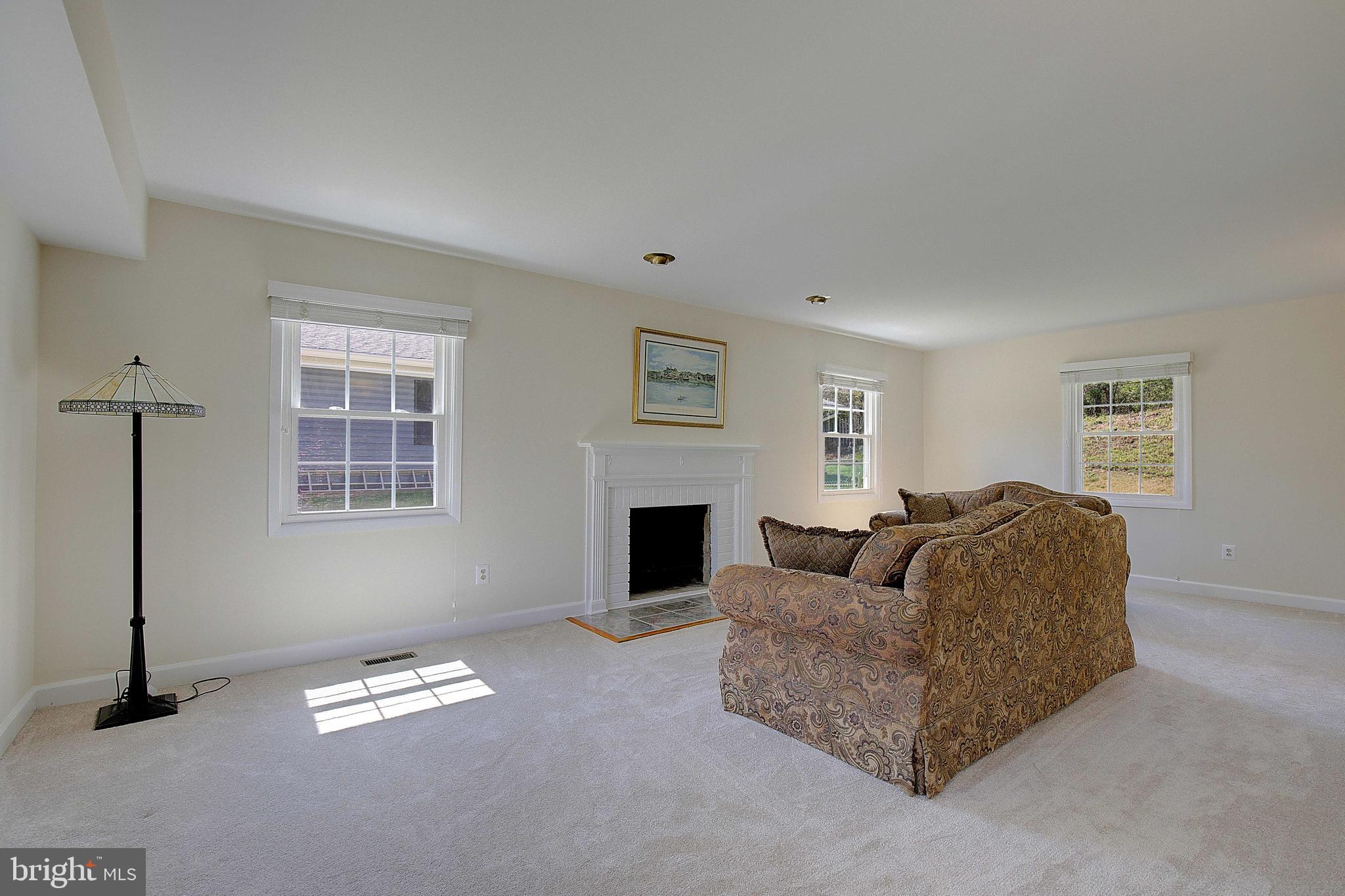 12702 Cedarbrook Lane Laurel, MD 20708 - Photo 6 of 43 a living room with furniture a fireplace and a window