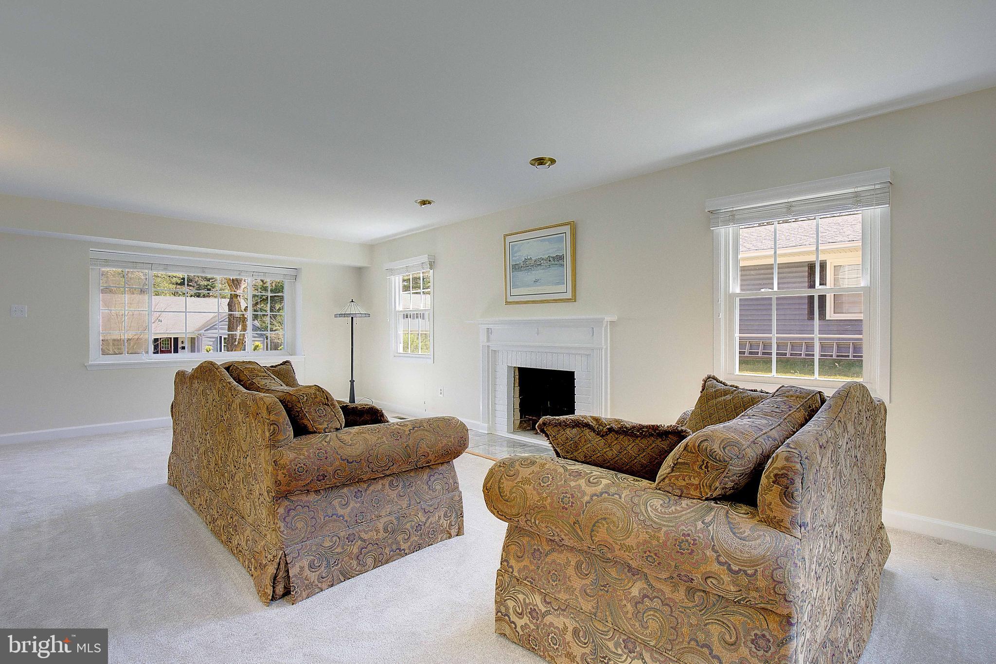 12702 Cedarbrook Lane Laurel, MD 20708 - Photo 8 of 43 a living room with furniture a fireplace and a window