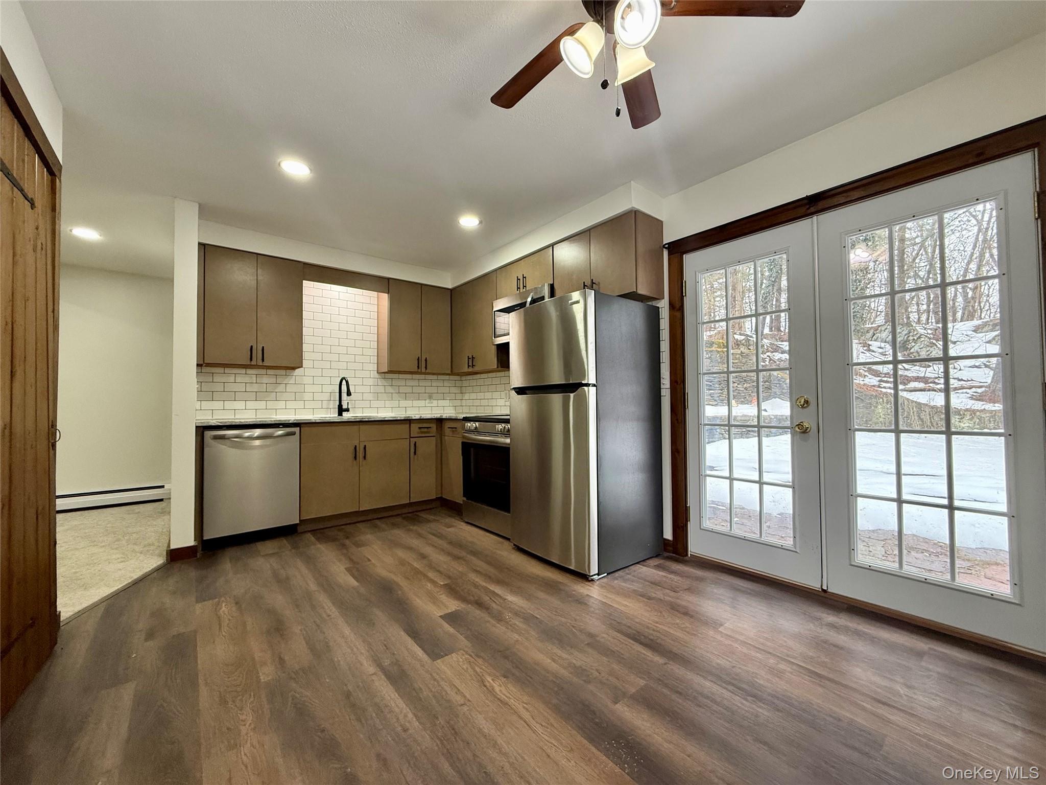 102 Fallkill Road, Unit 1W Hyde Park, NY 12538 - Photo 9 of 21 a large kitchen with a large window stainless steel appliances and cabinets
