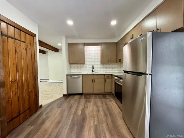 a kitchen with a refrigerator a sink and cabinets