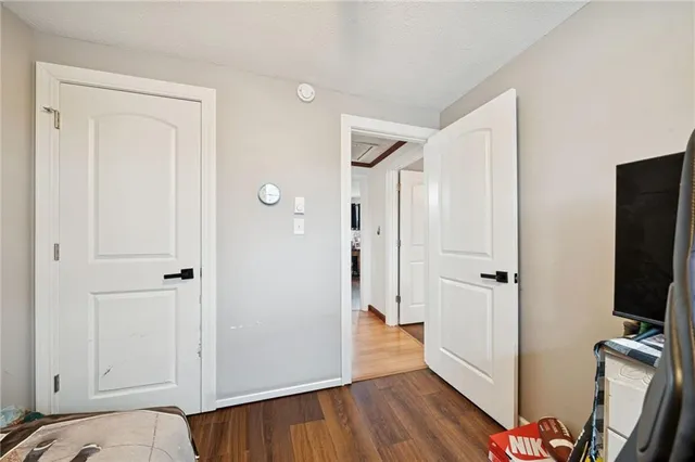 a view of a bedroom with a hardwood and hallway