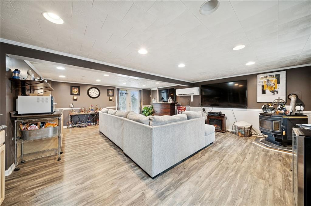 440 Lippencott Run Road Waynesburg, PA 15370 - Photo 18 of 39 a living room with furniture and a flat screen tv