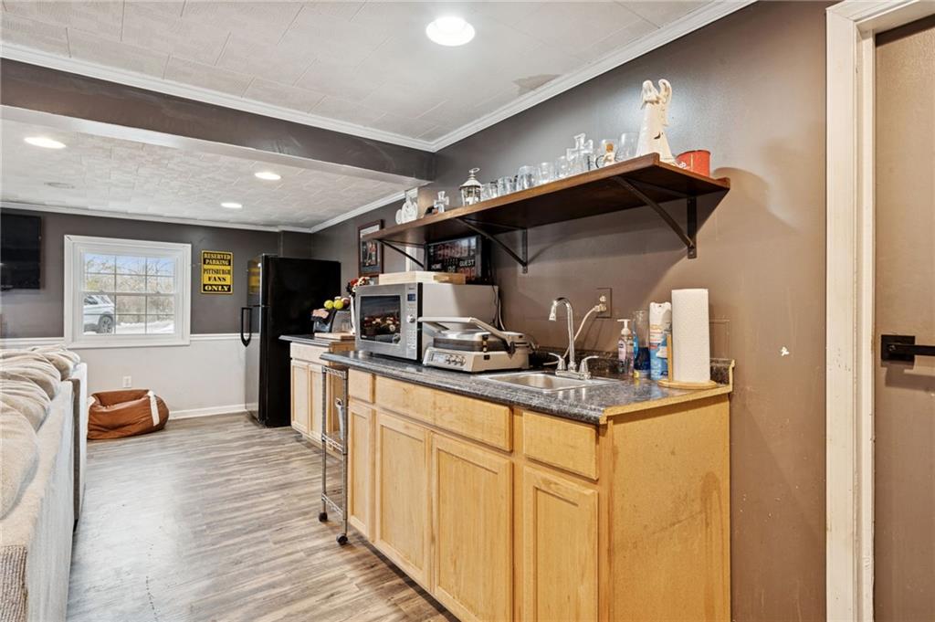 440 Lippencott Run Road Waynesburg, PA 15370 - Photo 22 of 39 a kitchen with stainless steel appliances granite countertop a sink and cabinets