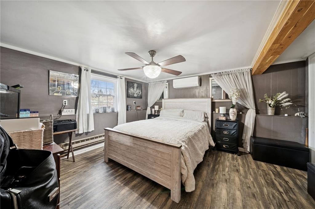 440 Lippencott Run Road Waynesburg, PA 15370 - Photo 26 of 39 a bedroom with a bed and wooden floor