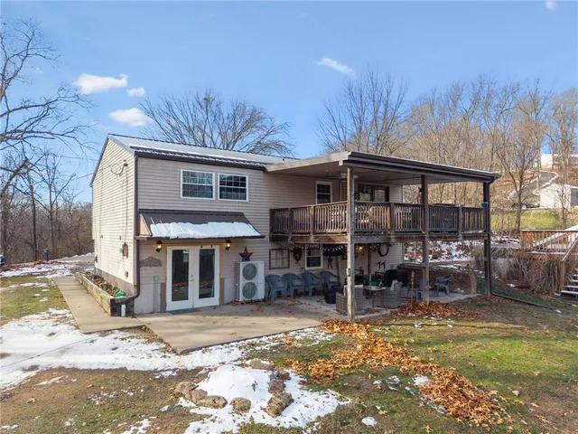 a view of a house with backyard porch and sitting area