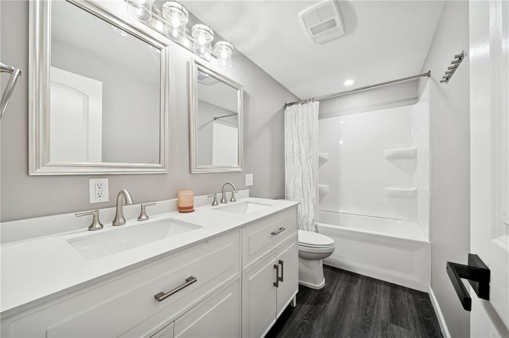 440 Lippencott Run Road Waynesburg, PA 15370 - Photo 9 of 39 a bathroom with a double vanity sink toilet and shower