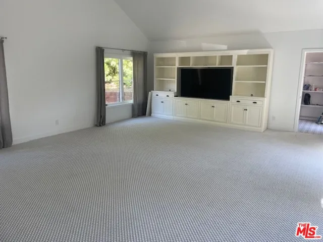 a living room with a flat screen tv and a fireplace