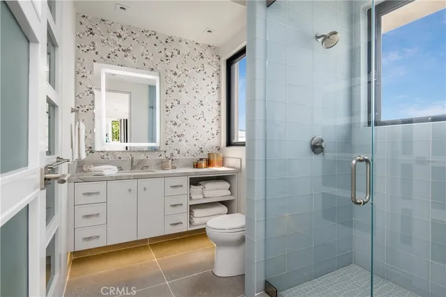 a bathroom with a granite countertop sink toilet and shower