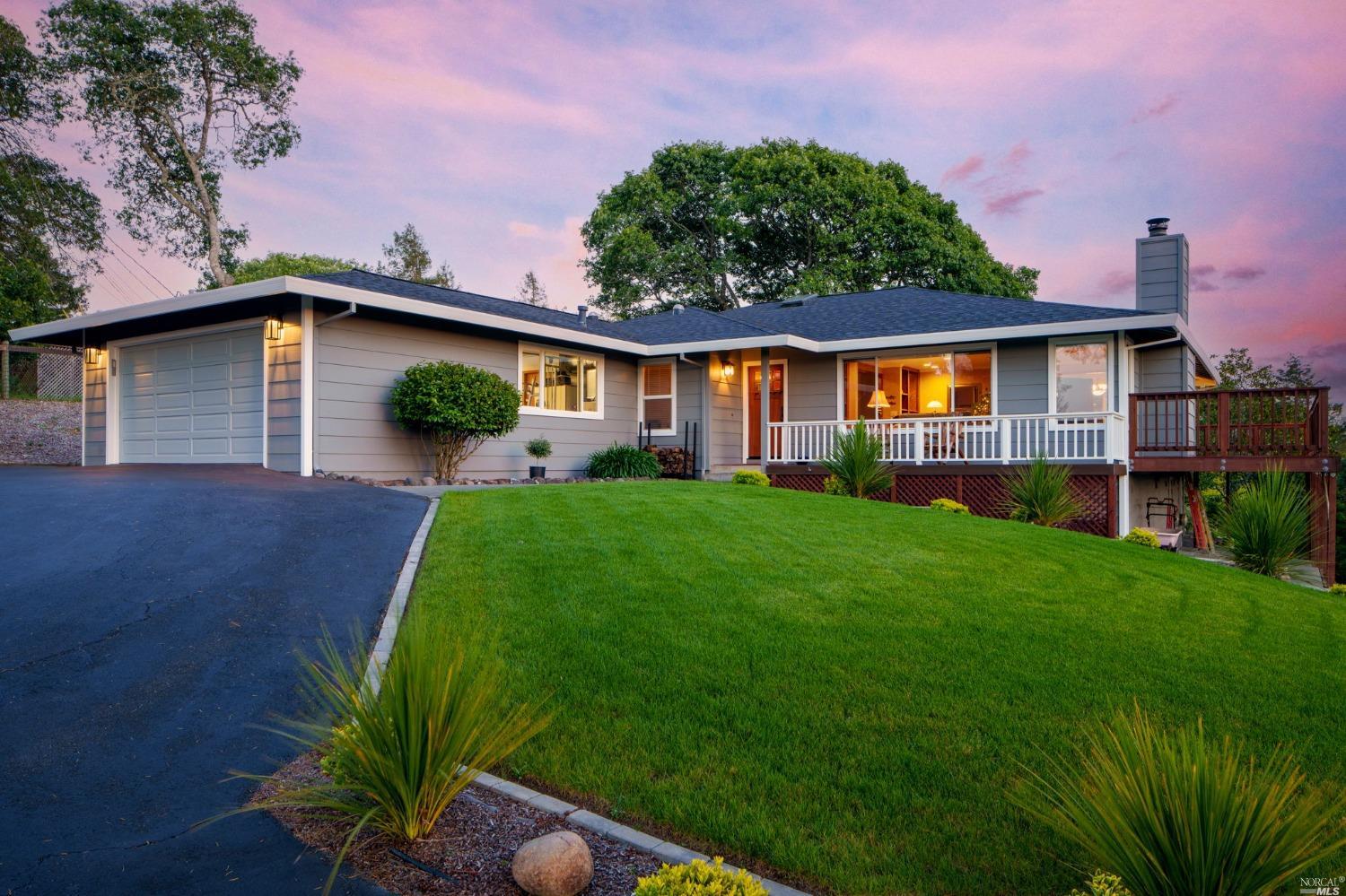 a front view of a house with a garden and yard