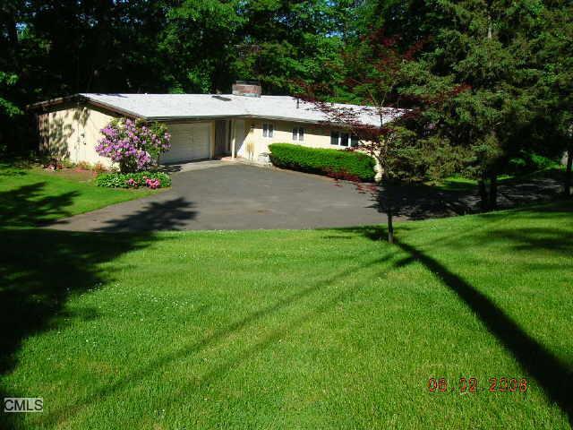 57 Spoonwood Road Wilton, CT 06897 - Photo 1 of 1 a view of backyard with plants and outdoor seating