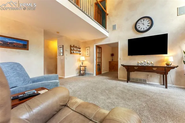 a living room with furniture a flat screen tv and a wall