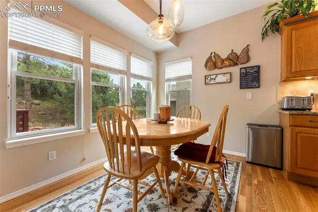 a view of a dining room with furniture window and wooden floor