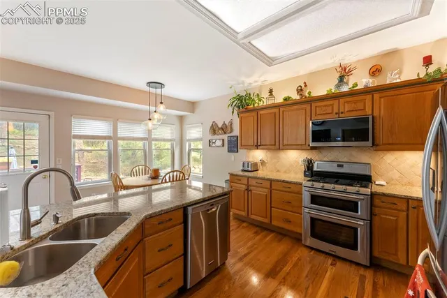 a kitchen with granite countertop a stove and a sink