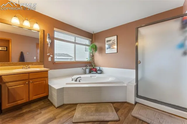 a spacious bathroom with a bathtub and a sink