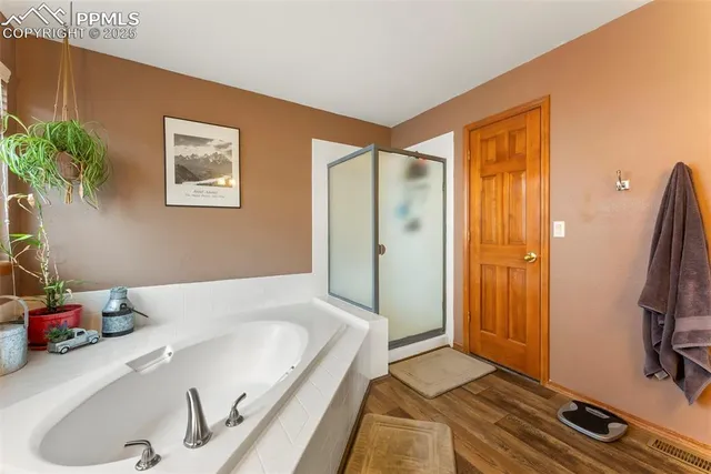a bathroom with a tub and shower