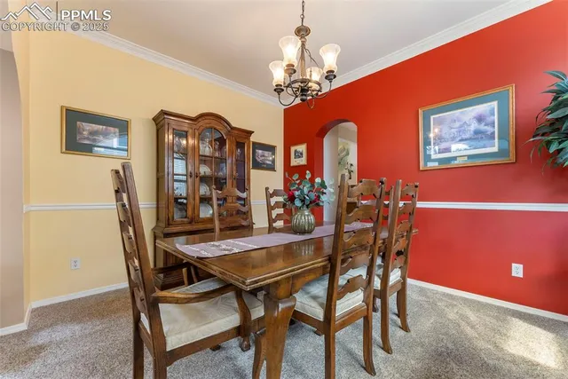 a view of a dining room with furniture and chandelier