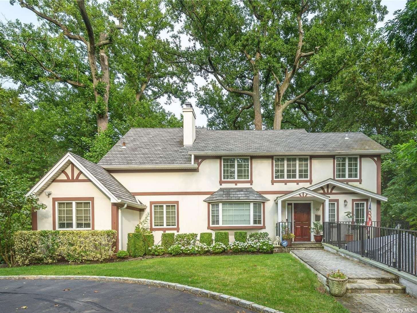 99 Station Road Great Neck, NY 11023 - Photo 1 of 1 a front view of a house with a garden