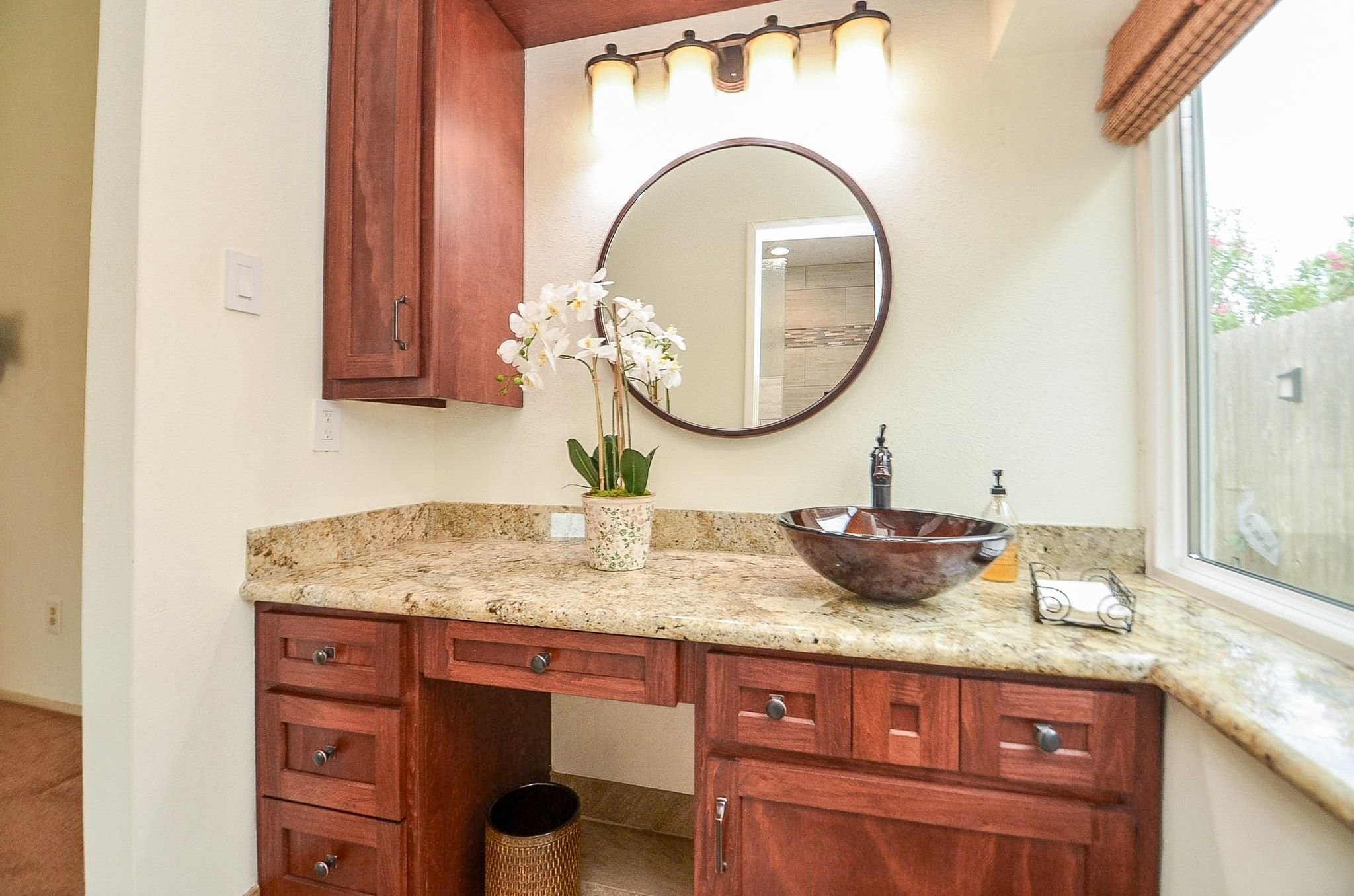 22810 John Rolfe Lane Katy, TX 77449 - Photo 15 of 20 a bathroom with a granite countertop sink and a mirror