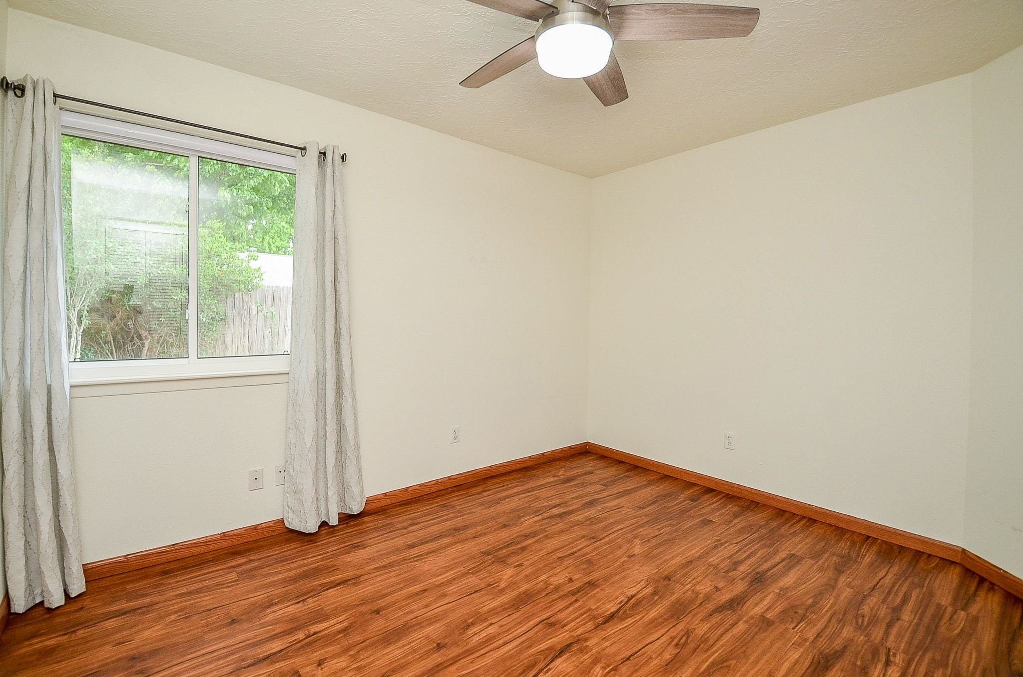 22810 John Rolfe Lane Katy, TX 77449 - Photo 16 of 20 a view of empty room with wooden floor