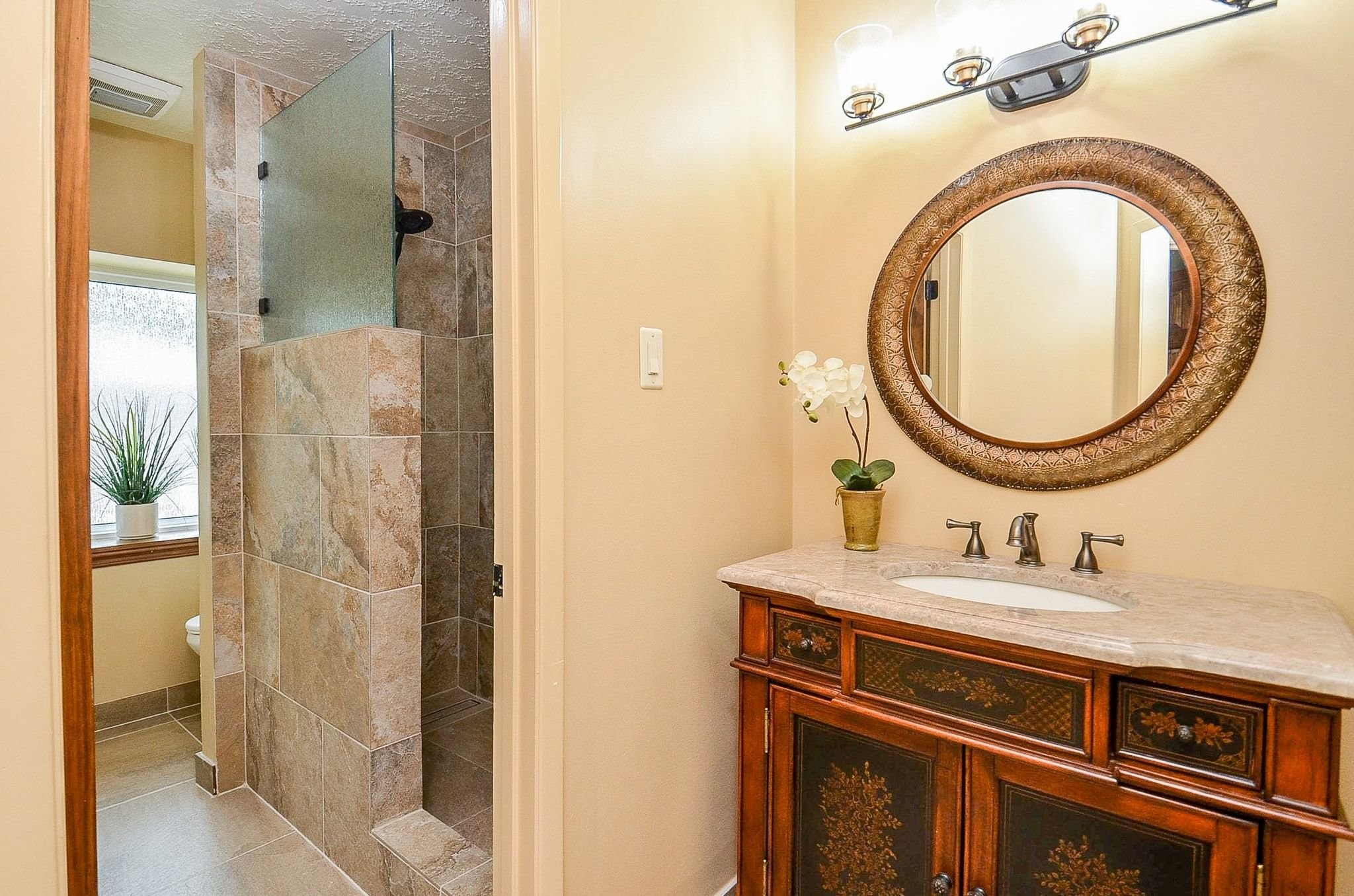 22810 John Rolfe Lane Katy, TX 77449 - Photo 18 of 20 a bathroom with a sink and a mirror