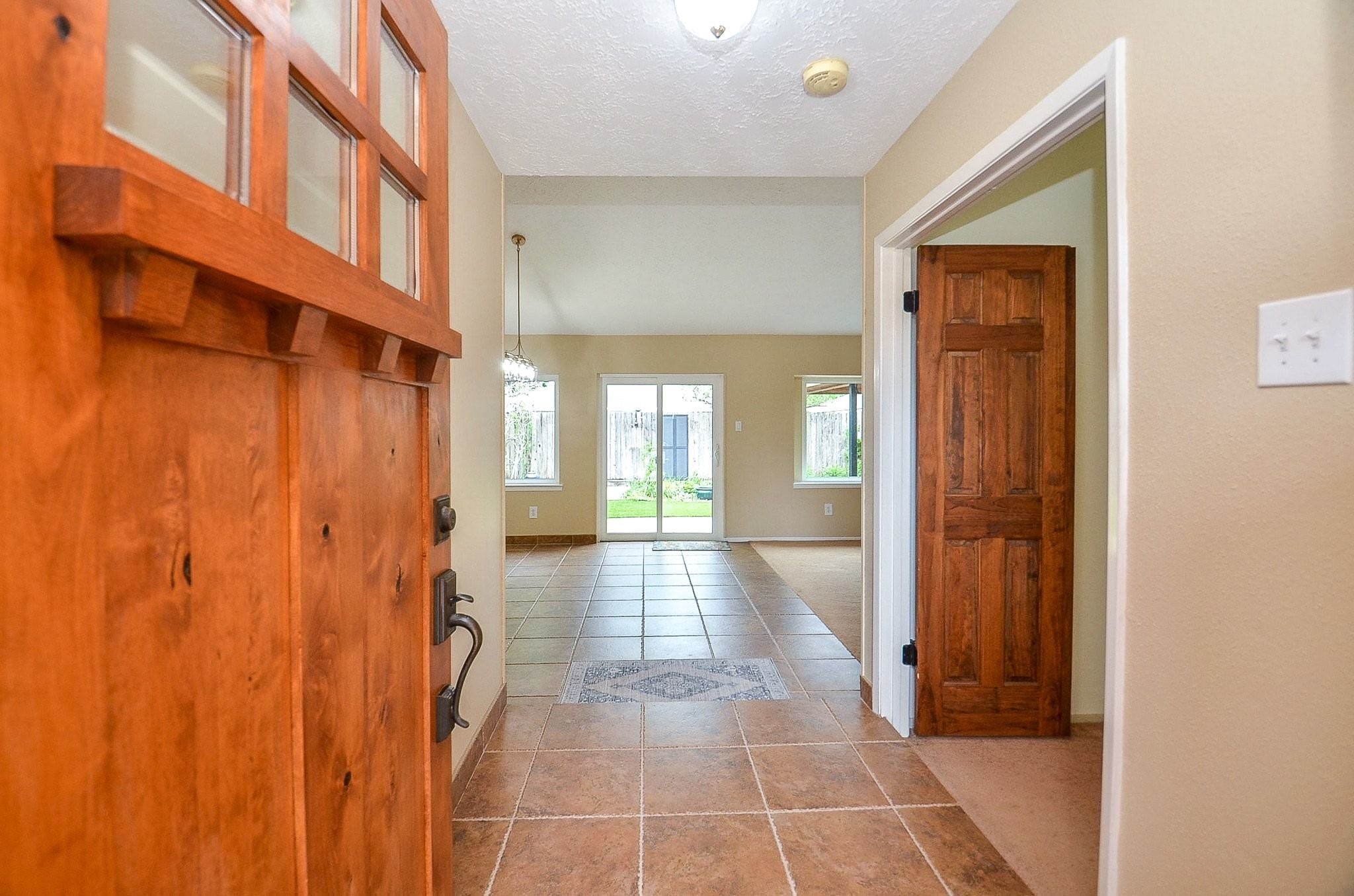 22810 John Rolfe Lane Katy, TX 77449 - Photo 3 of 20 a view of a hallway with wooden floor and a bathroom
