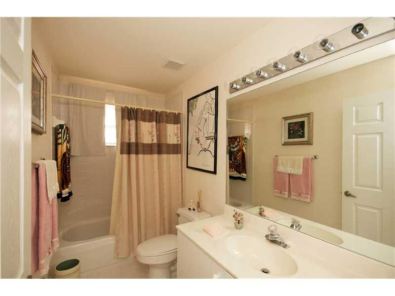 10154 Aqua Vista Way Boca Raton, FL 33428 - Photo 13 of 22 a bathroom with a sink mirror and shower