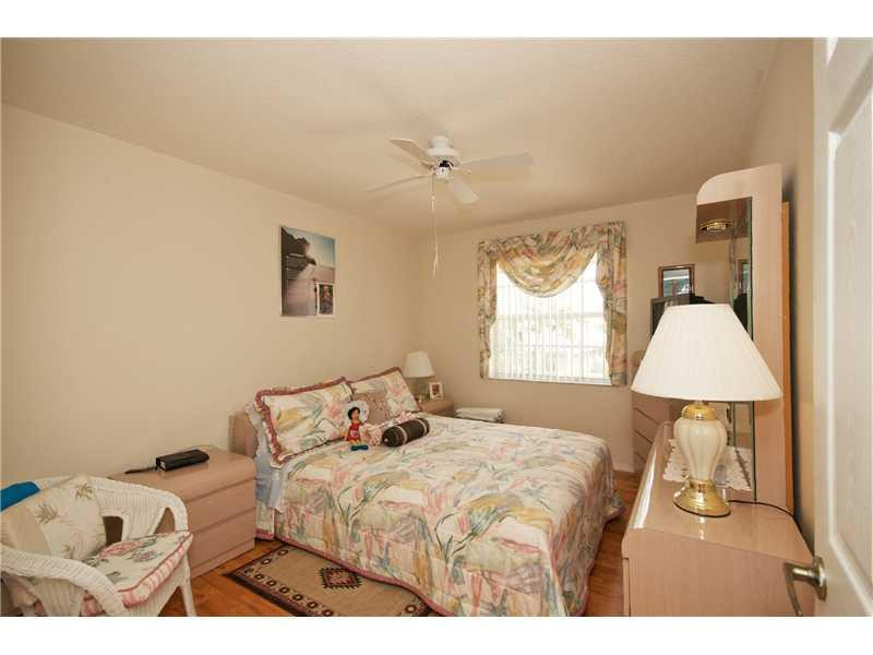 10154 Aqua Vista Way Boca Raton, FL 33428 - Photo 14 of 22 a bedroom with a bed and a lamp
