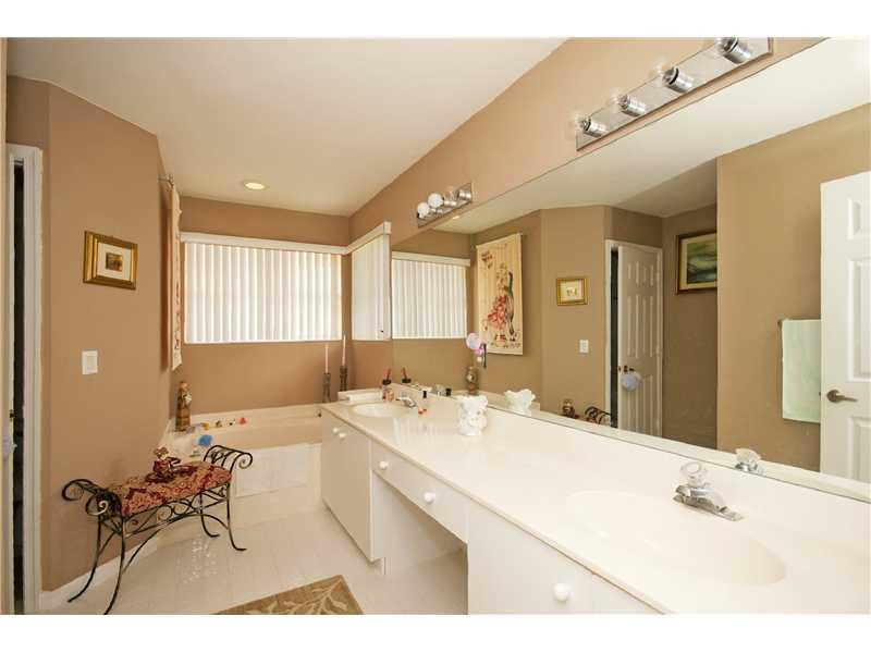 10154 Aqua Vista Way Boca Raton, FL 33428 - Photo 17 of 22 a bathroom with a sink mirror and a bath tub
