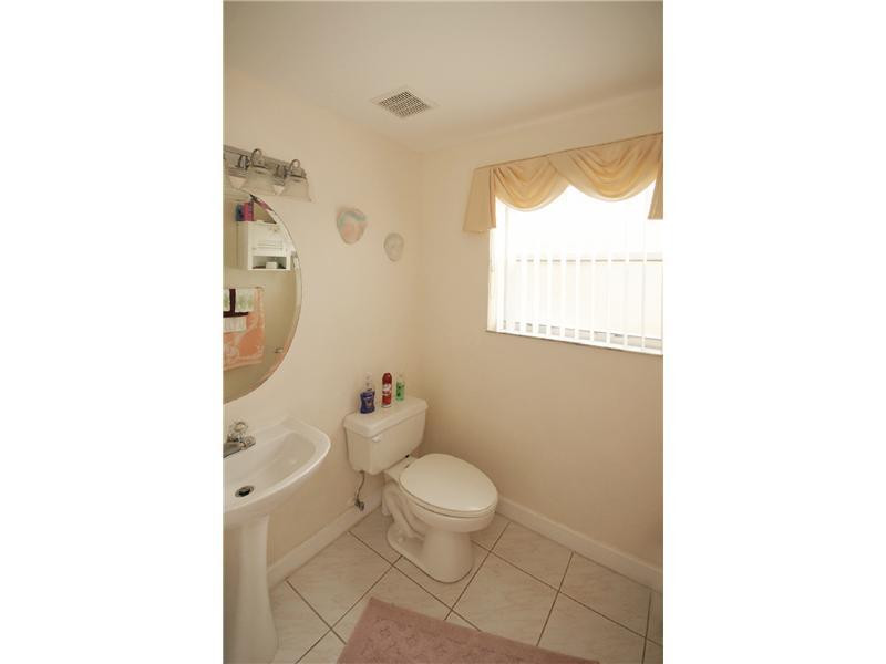 10154 Aqua Vista Way Boca Raton, FL 33428 - Photo 18 of 22 a bathroom with a toilet and a shower curtain