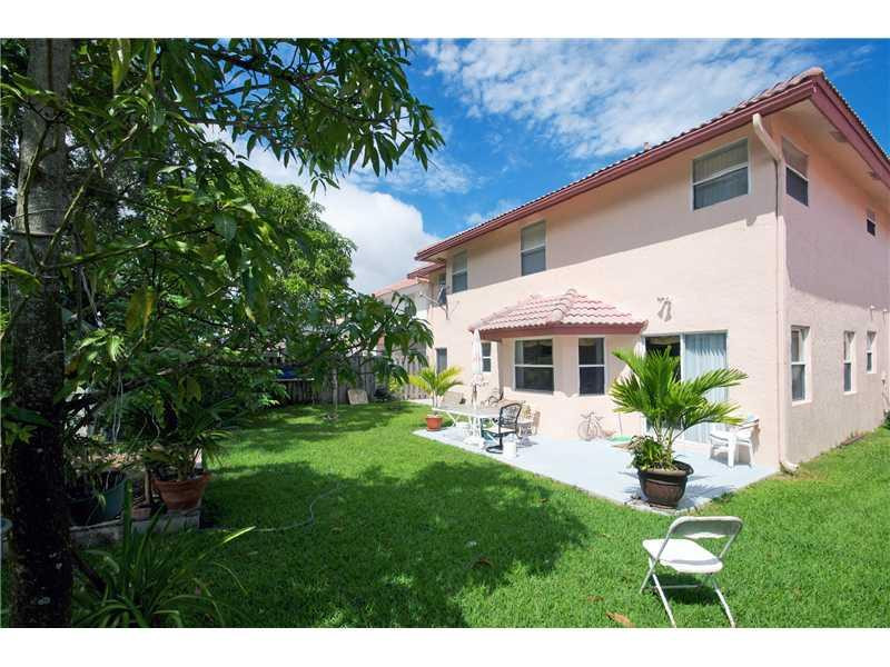 10154 Aqua Vista Way Boca Raton, FL 33428 - Photo 20 of 22 a front view of a house with a garden and yard