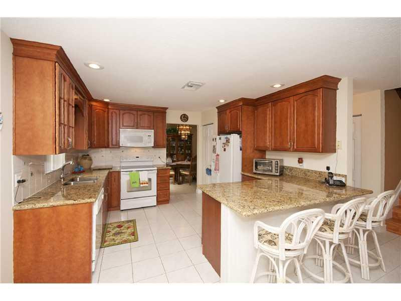 10154 Aqua Vista Way Boca Raton, FL 33428 - Photo 4 of 22 a kitchen with stainless steel appliances granite countertop a sink a stove counter space and cabinets