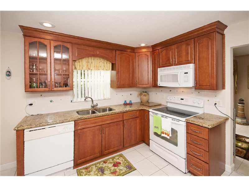10154 Aqua Vista Way Boca Raton, FL 33428 - Photo 5 of 22 a kitchen with stainless steel appliances granite countertop a sink stove and cabinets