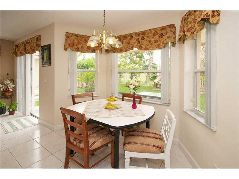 10154 Aqua Vista Way Boca Raton, FL 33428 - Photo 7 of 22 a view of a dining room with furniture a chandelier and large window
