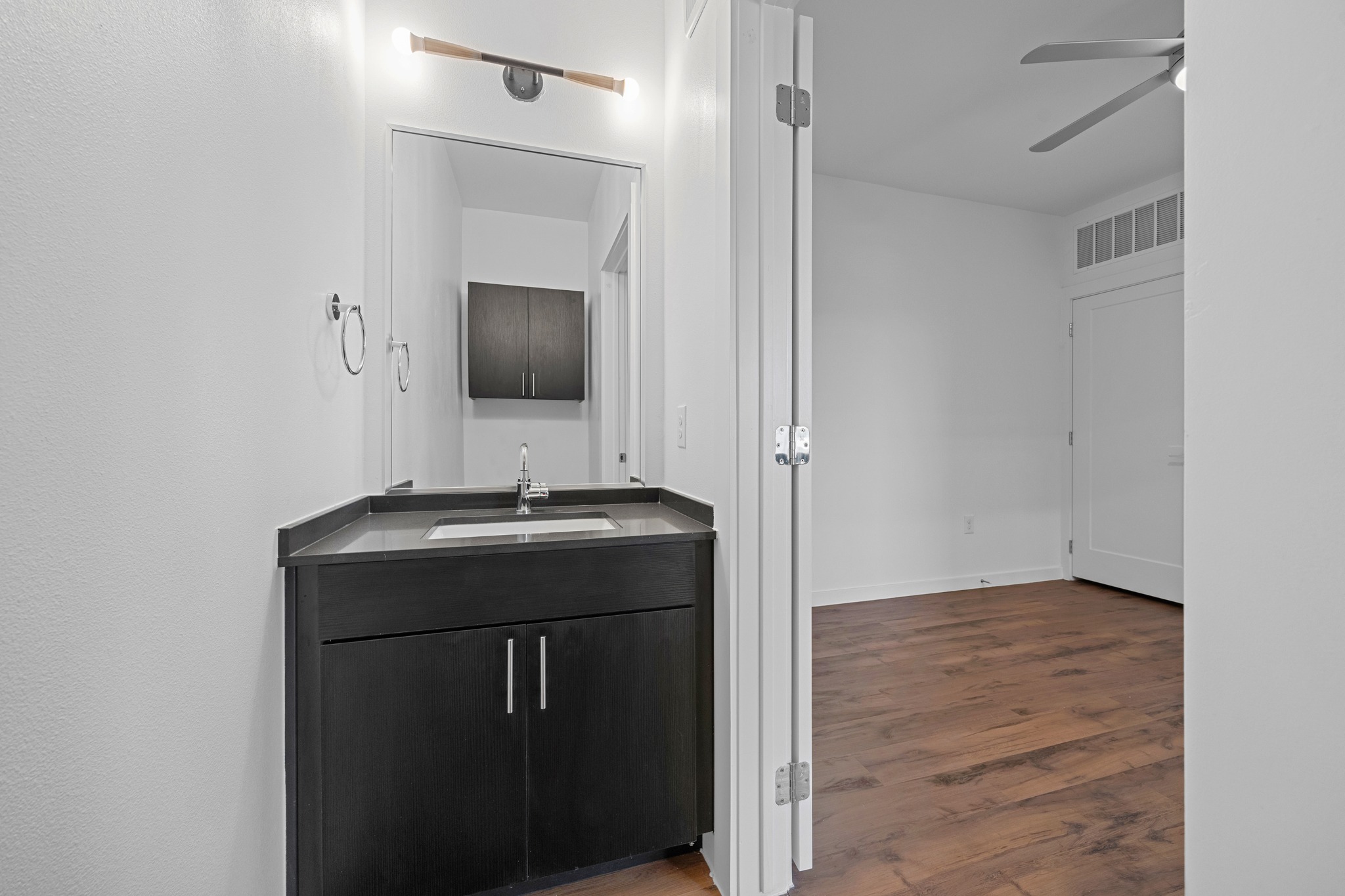 4801 Springdale Road, Unit 2301 Austin, TX 78723 - Photo 20 of 36 A well-appointed vanity with dark cabinetry and ample counter space for daily routines.