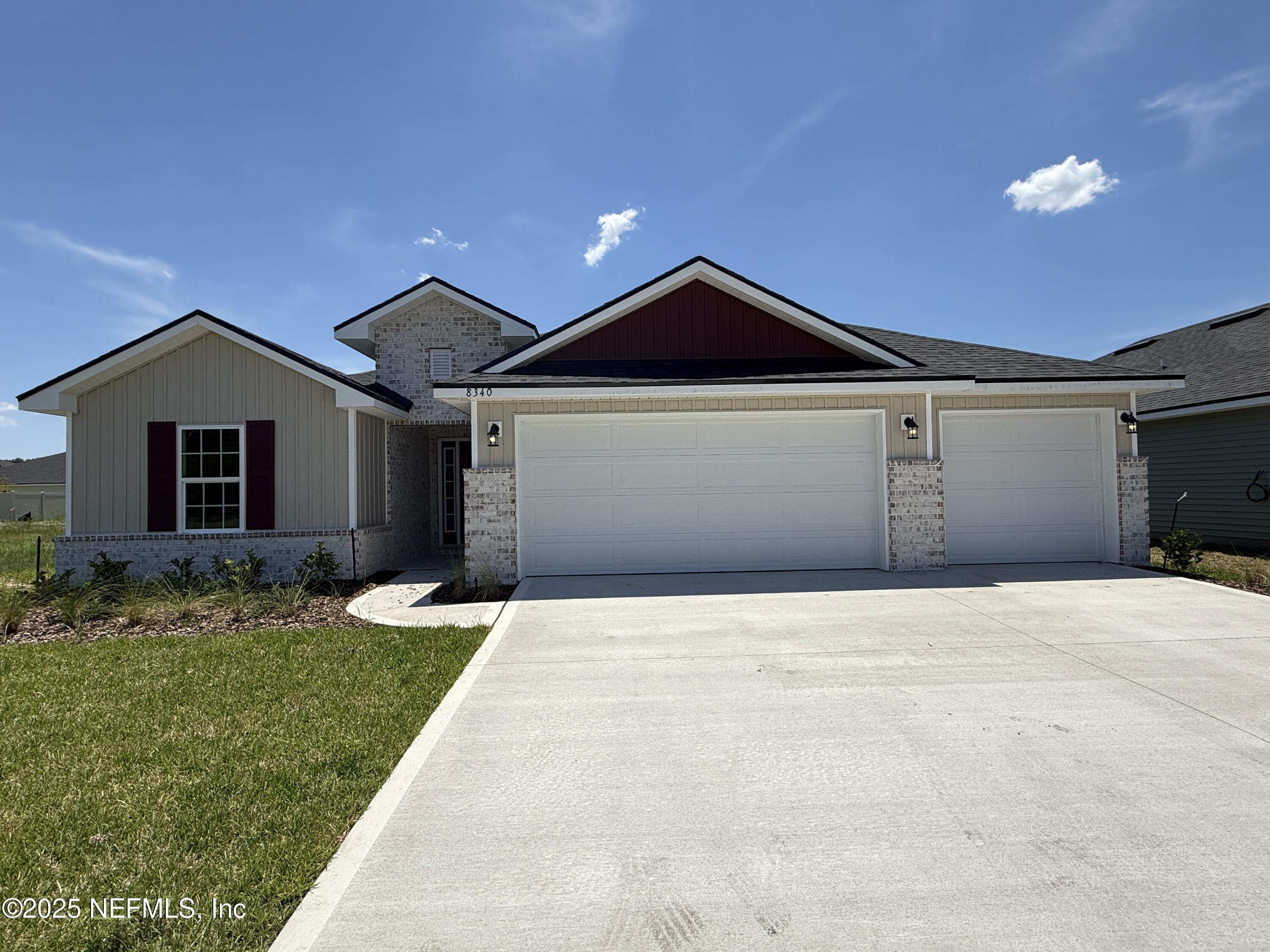 8340 Helmsley Boulevard Jacksonville, FL 32219 - Photo 1 of 56 a front view of a house with a yard