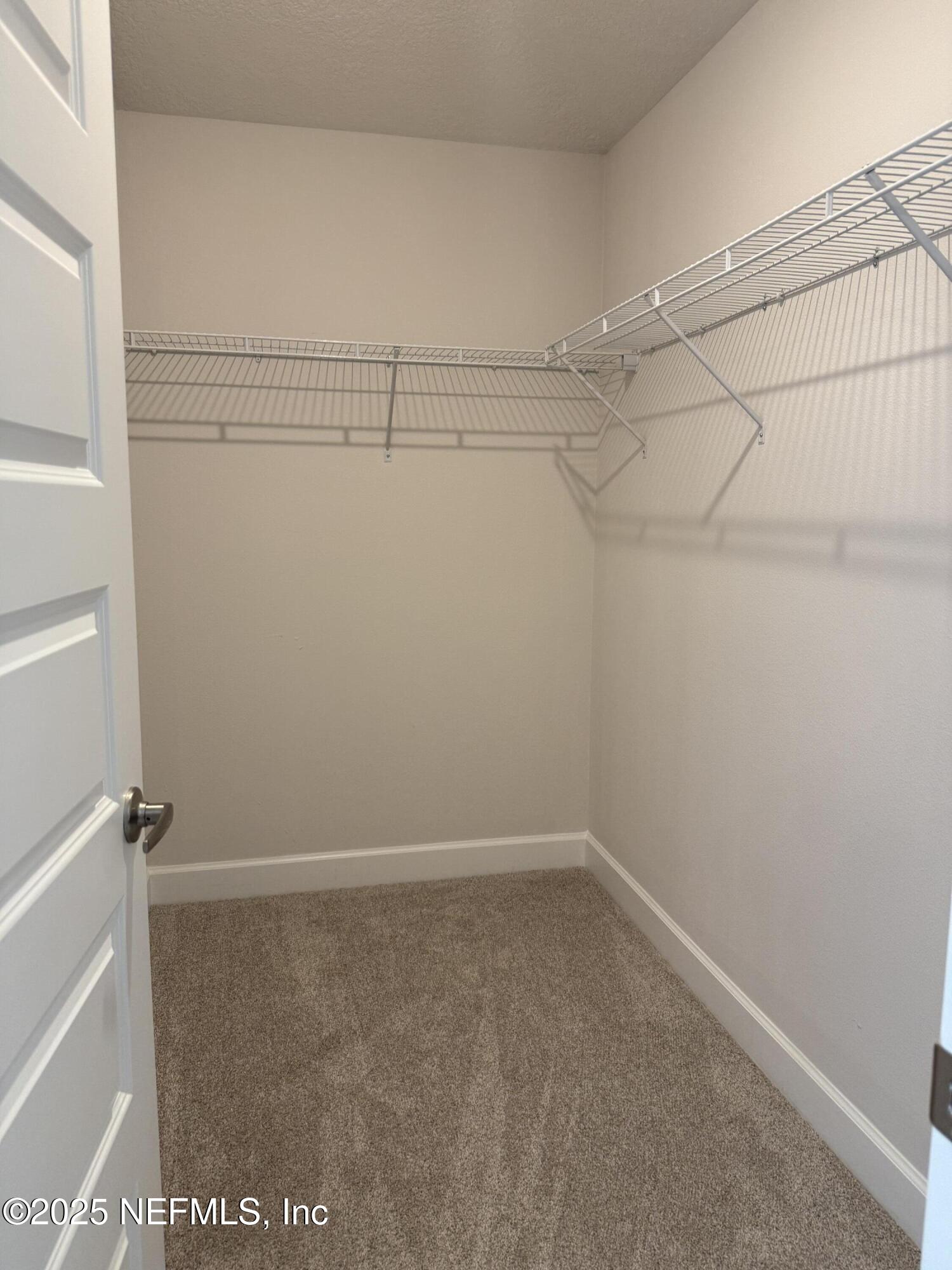 8340 Helmsley Boulevard Jacksonville, FL 32219 - Photo 17 of 56 a view of a room with racks on the wall