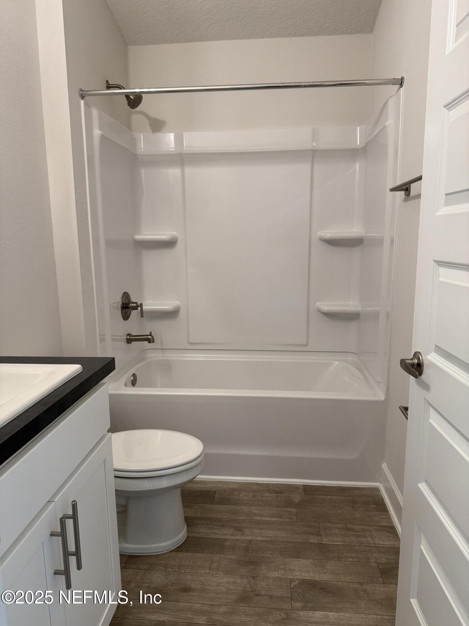 8340 Helmsley Boulevard Jacksonville, FL 32219 - Photo 21 of 56 a bathroom with a toilet and a bath tub