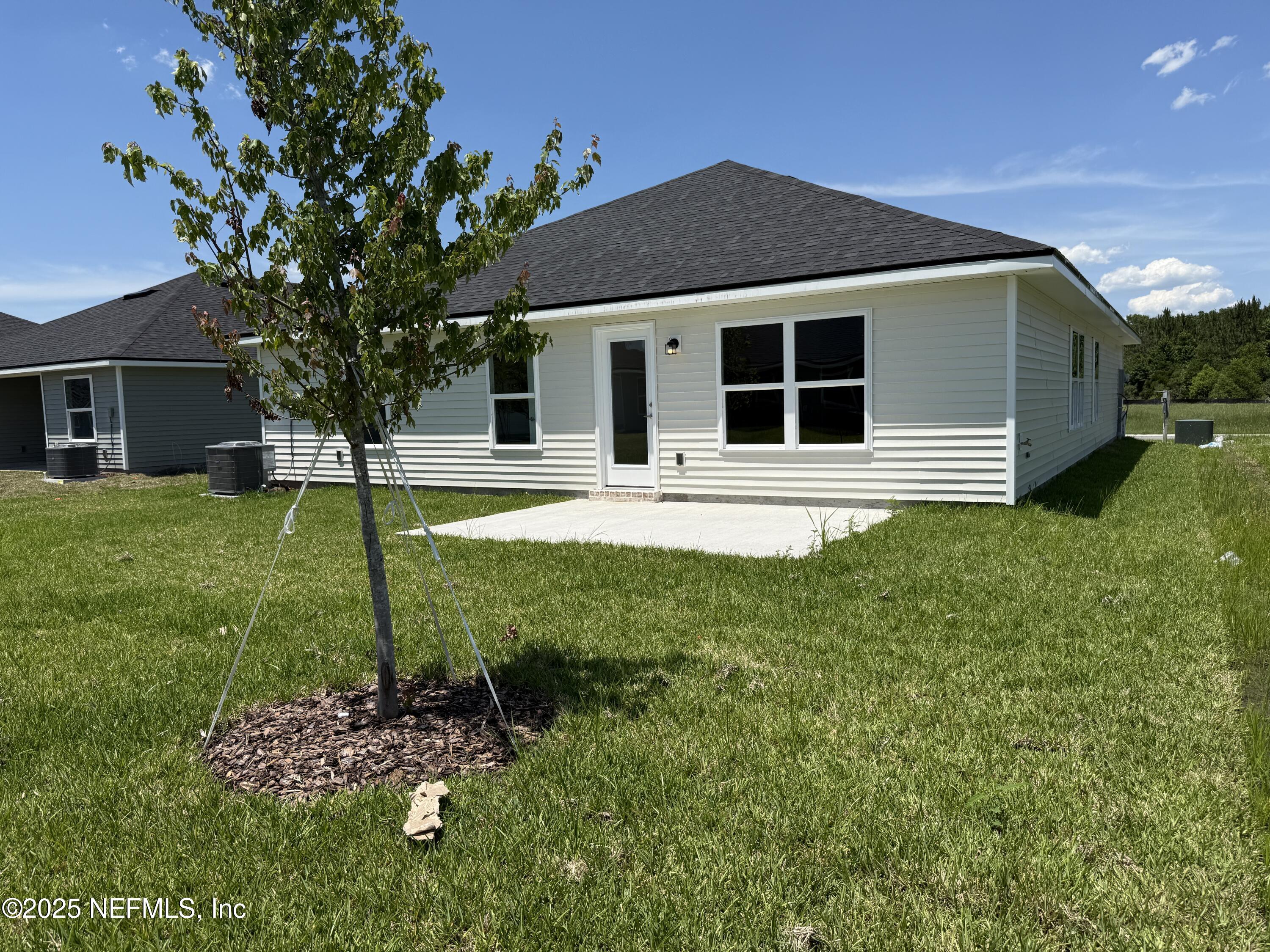 8340 Helmsley Boulevard Jacksonville, FL 32219 - Photo 26 of 56 a front view of a house with a yard