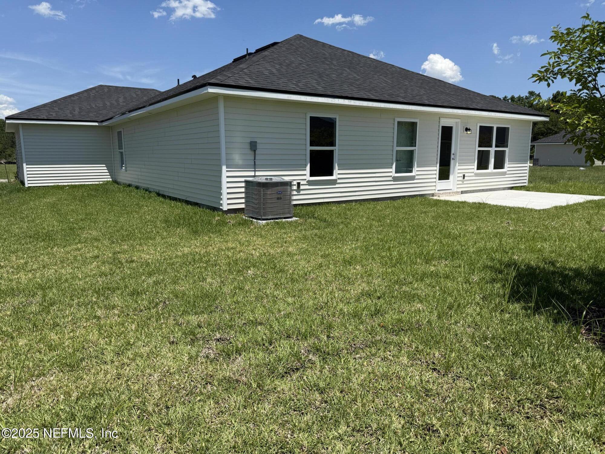 8340 Helmsley Boulevard Jacksonville, FL 32219 - Photo 27 of 56 a front view of a house with a yard