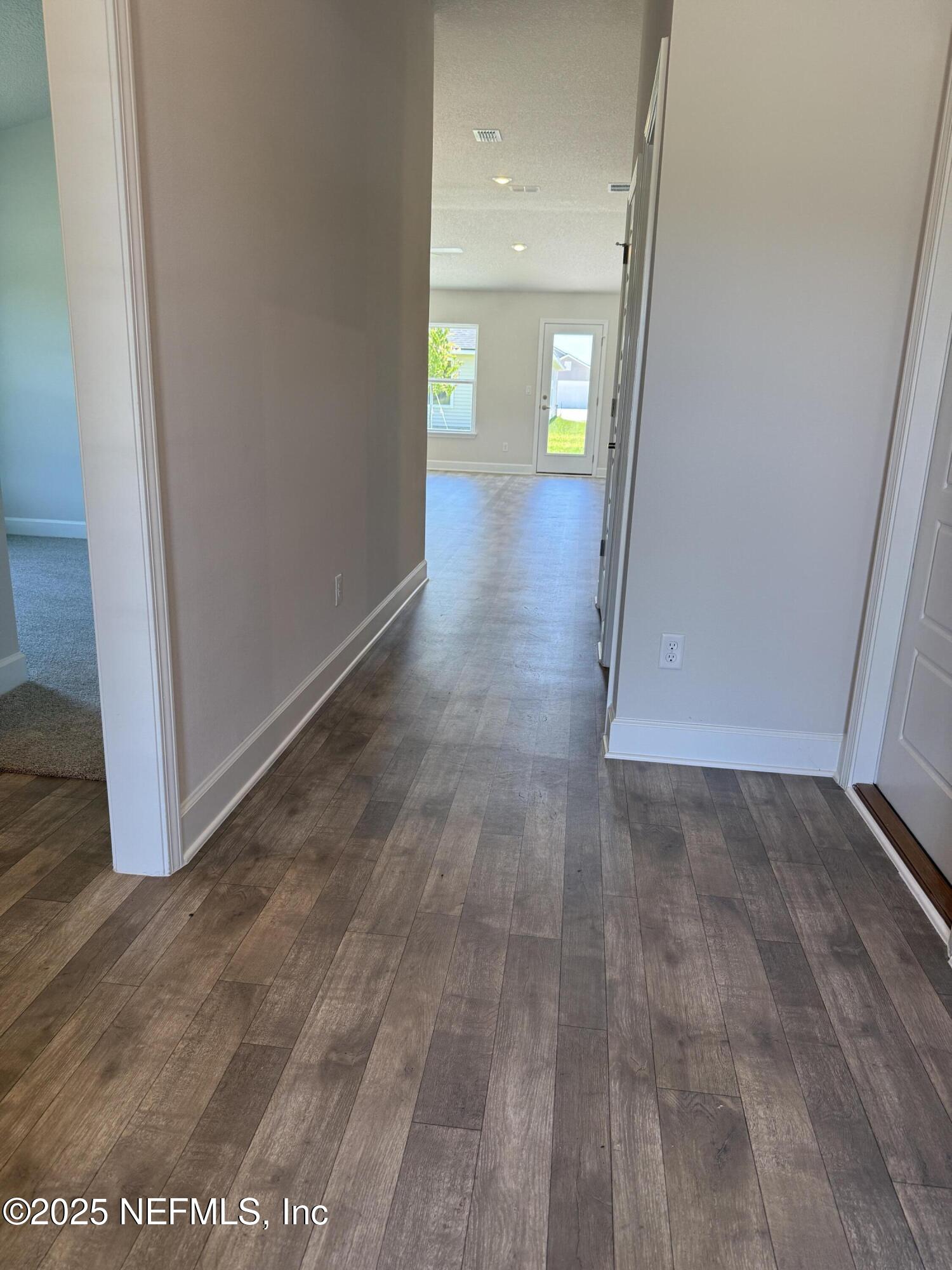 8340 Helmsley Boulevard Jacksonville, FL 32219 - Photo 3 of 56 a view of a hallway with wooden floor