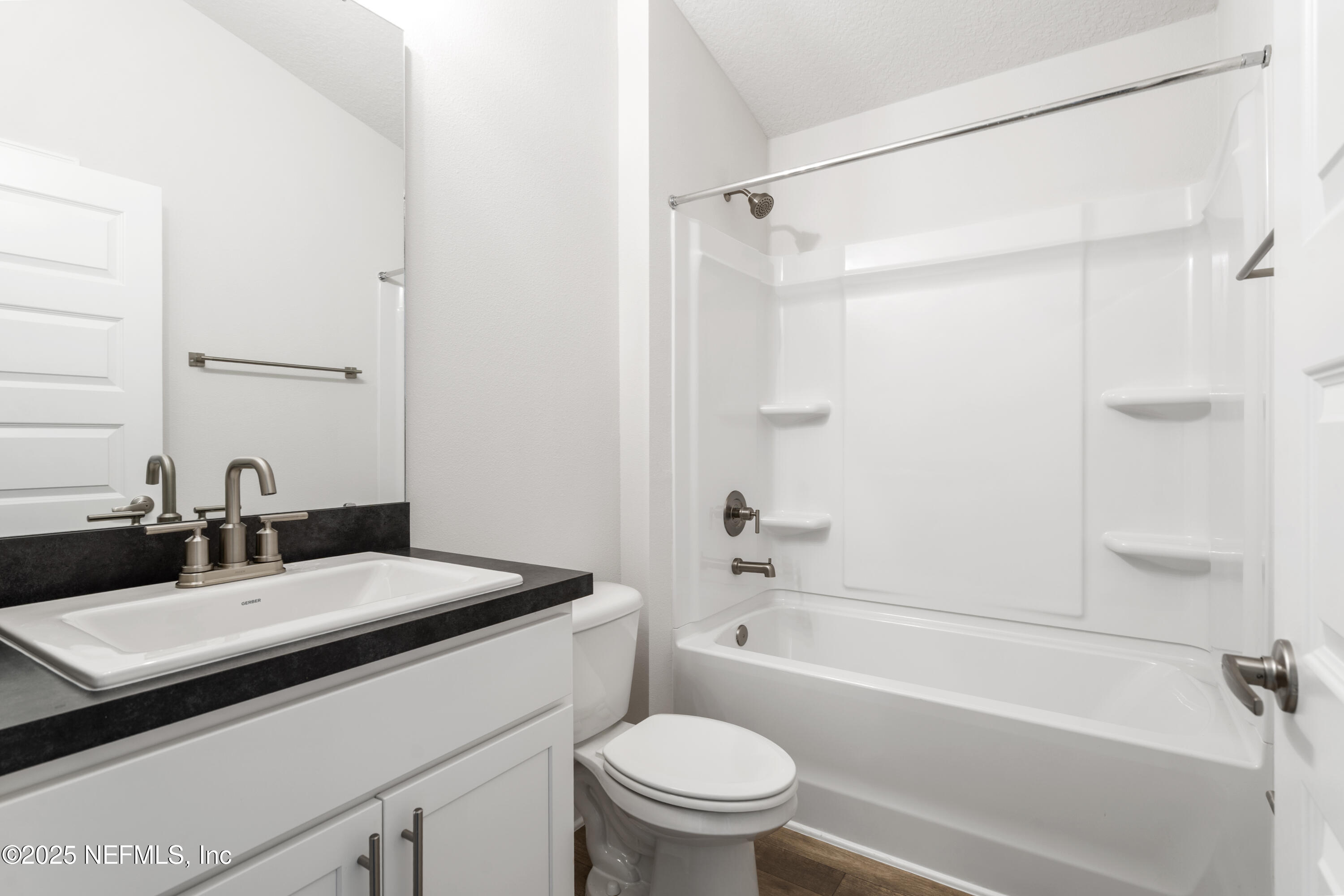 8340 Helmsley Boulevard Jacksonville, FL 32219 - Photo 40 of 56 a bathroom with a sink toilet vanity and shower