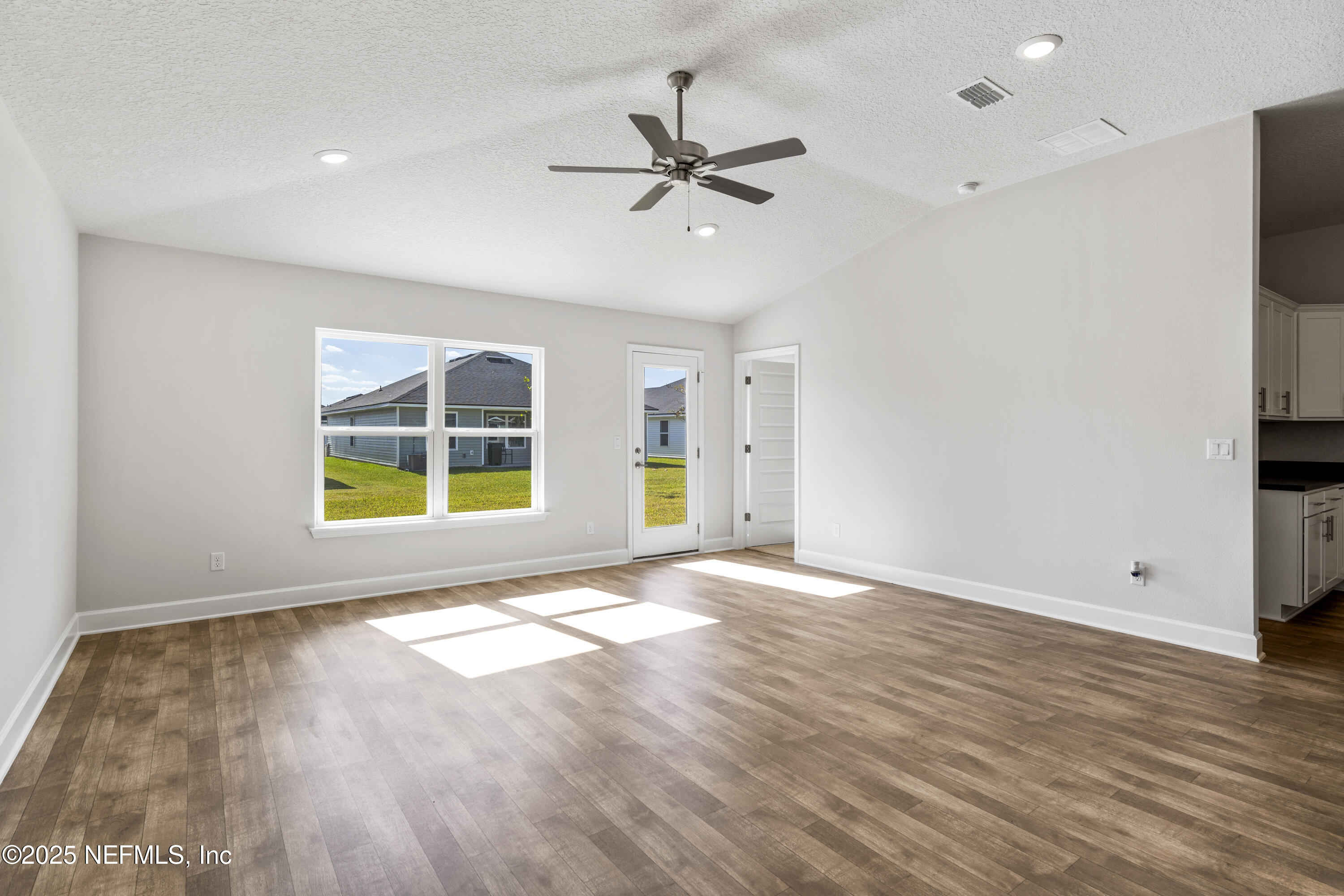 8340 Helmsley Boulevard Jacksonville, FL 32219 - Photo 45 of 56 a view of an empty room with a window and wooden floor