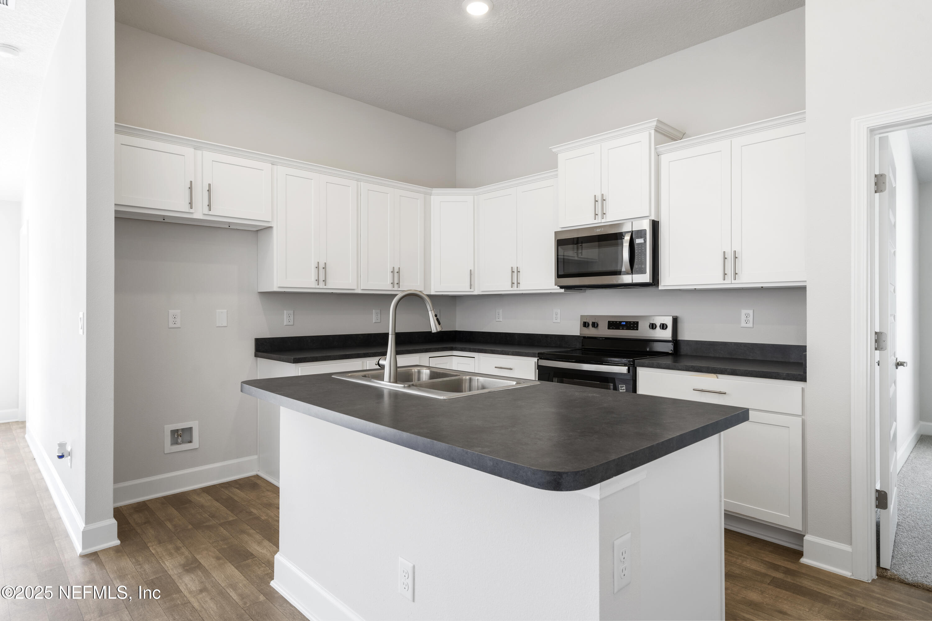8340 Helmsley Boulevard Jacksonville, FL 32219 - Photo 48 of 56 a kitchen with stainless steel appliances granite countertop a sink stove microwave and refrigerator