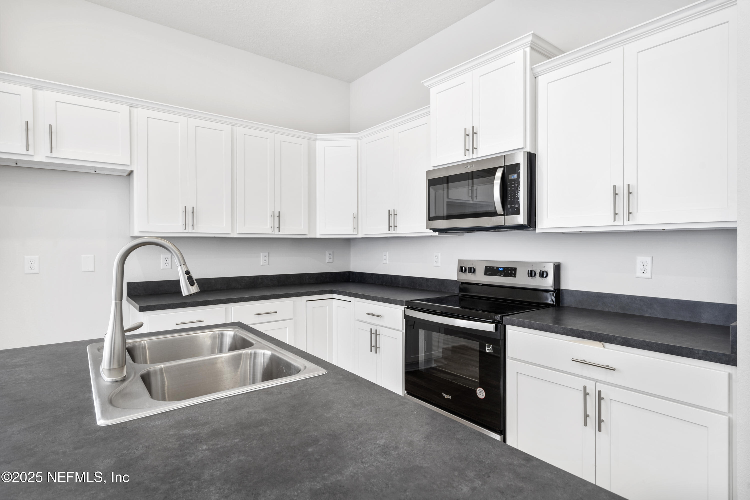 8340 Helmsley Boulevard Jacksonville, FL 32219 - Photo 49 of 56 a kitchen with granite countertop white cabinets and stainless steel appliances